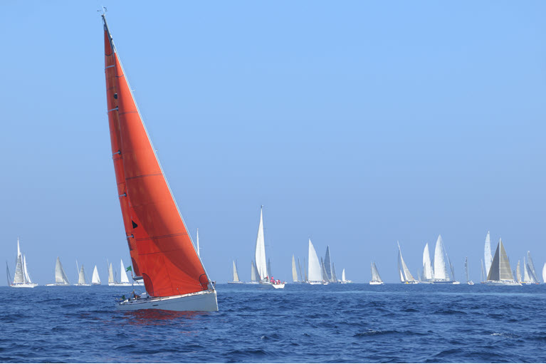 red boat in the middle of many boats to demonstrate the uniqueness of our approach