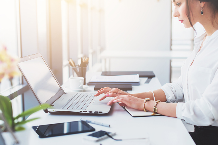 Une femme assise à un bureau.