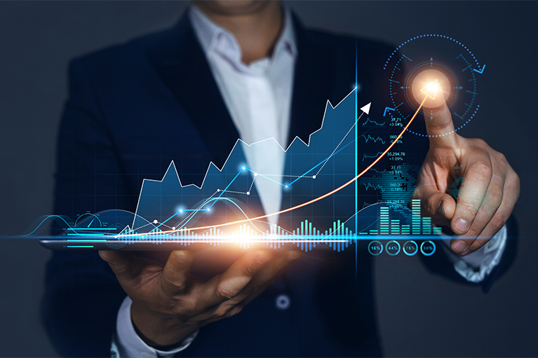 Image of a man holding a digital financial graph.