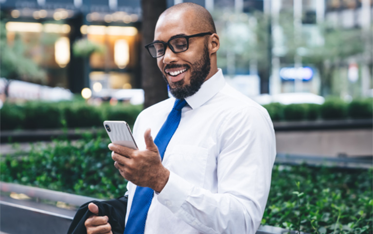 Un homme regarde son téléphone intelligent.