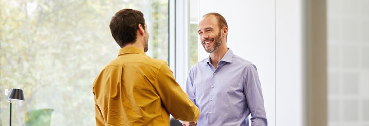 Client souriant faisant affaire avec son conseiller en gestion de patrimoine